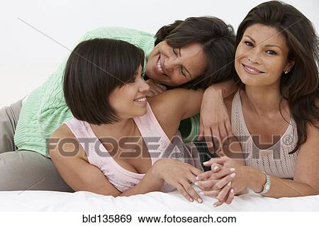 Hispanic mother and daughters relaxing together View Large Photo Image Stock Photo - Hispanic mother and daughters relaxing together. Fotosearch