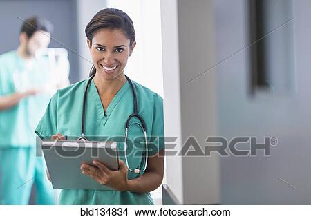 Picture - Hispanic nurse working in hospital. Fotosearch