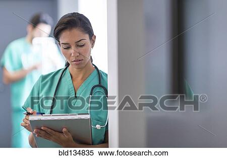Hispanic nurse working in hospital View Large Photo Image Stock Photography - Hispanic nurse working in hospital. Fotosearch