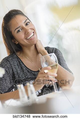 Hispanic woman drinking wine at dinner View Large Photo Image Stock Photo - Hispanic woman drinking wine at dinner. Fotosearch