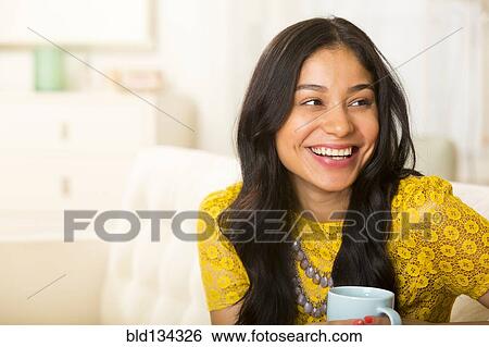 Hispanic woman having cup of coffee View Large Photo Image Stock Photograph - Hispanic woman having cup of coffee. Fotosearch