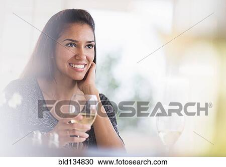 Hispanic woman having glass of wine in restaurant View Large Photo Image Stock Image - Hispanic woman having glass of wine in restaurant. Fotosearch