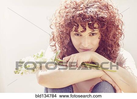 Picture - Hispanic woman holding bouquet of flowers. Fotosearch