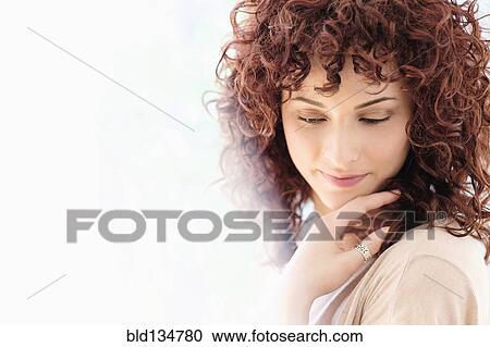Hispanic woman holding chin in hands View Large Photo Image Stock Image - Hispanic woman holding chin in hands. Fotosearch