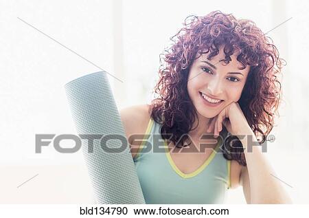 Hispanic woman holding yoga mat View Large Photo Image Stock Image - Hispanic woman holding yoga mat. Fotosearch