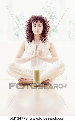 Hispanic woman meditating with candle View Large Photo Image Stock Image - Hispanic woman meditating with candle. Fotosearch