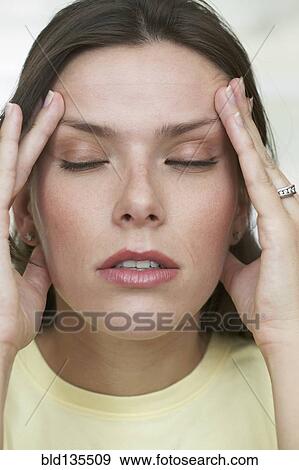 Hispanic woman rubbing her temples View Large Photo Image Stock Photo - Hispanic woman rubbing her temples. Fotosearch