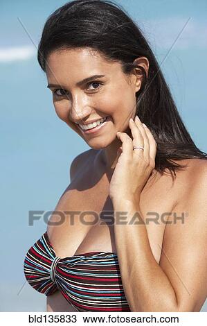 Hispanic woman smiling on beach View Large Photo Image Stock Image - Hispanic woman smiling on beach. Fotosearch