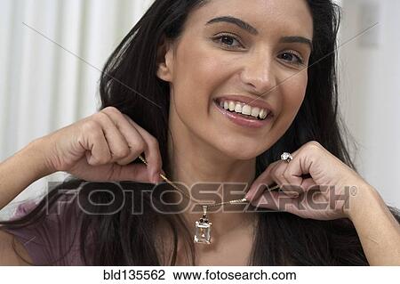 Hispanic woman trying on necklace View Large Photo Image Stock Image - Hispanic woman trying on necklace. Fotosearch
