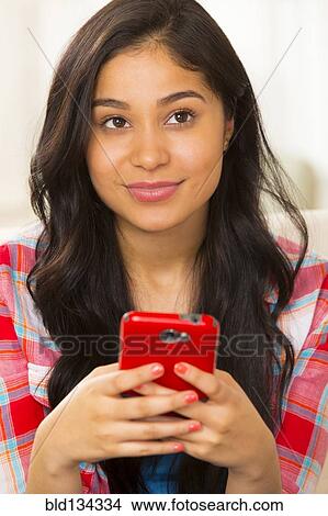 Hispanic woman using cell phone View Large Photo Image Picture - Hispanic woman using cell phone. Fotosearch