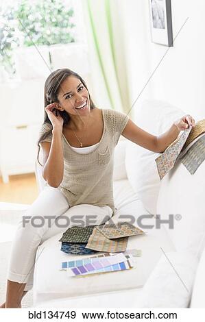 Hispanic woman with fabric swatches on sofa View Large Photo Image Stock Photo - Hispanic woman with fabric swatches on sofa. Fotosearch