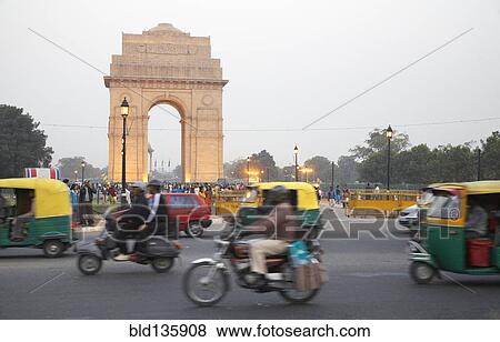 Stock Photo - India Gate overlooking busy city street, Delhi, India. Fotosearch