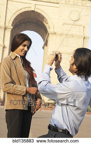 Indian couple taking pictures by monument, Delhi, India View Large Photo Image Stock Image - Indian couple taking pictures by monument, Delhi, India. Fotosearch