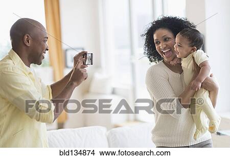 Man taking picture of mother and baby View Large Photo Image Picture - Man taking picture of mother and baby. Fotosearch