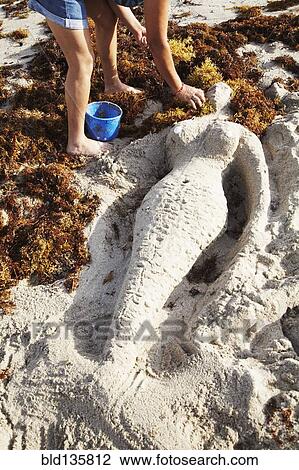 Mermaid sculpture in sand on beach View Large Photo Image Stock Image - Mermaid sculpture in sand on beach. Fotosearch