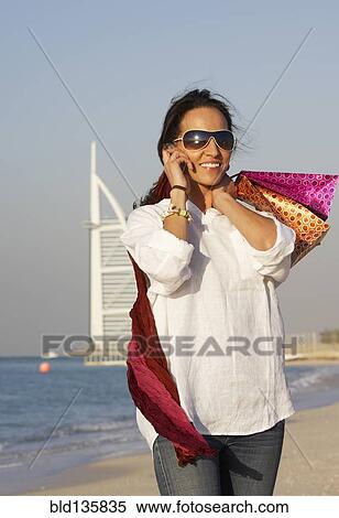Middle Eastern woman smiling on beach, Dubai, United Arab Emirates View Large Photo Image Stock Photography - Middle Eastern woman smiling on beach, Dubai, United Arab Emirates. Fotosearch