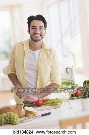 Mixed race man cooking in kitchen View Large Photo Image Picture - Mixed race man cooking in kitchen. Fotosearch