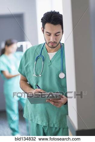 Stock Image - Mixed race nurse working in hospital. Fotosearch
