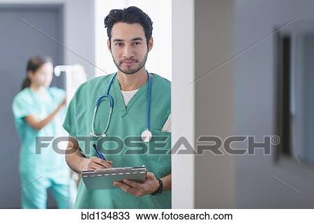 Stock Image - Mixed race nurse working in hospital. Fotosearch