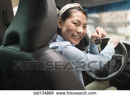 Mixed race teenage girl holding keys to car View Large Photo Image Stock Photo - Mixed race teenage girl holding keys to car. Fotosearch