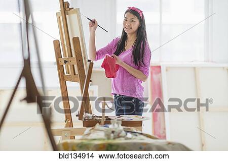 Mixed race teenage girl painting in studio View Large Photo Image Picture - Mixed race teenage girl painting in studio. Fotosearch