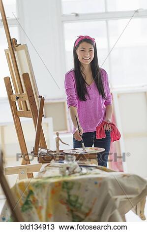 Mixed race teenage girl painting in studio View Large Photo Image Stock Image - Mixed race teenage girl painting in studio. Fotosearch
