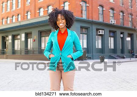 Mixed race woman standing on city street View Large Photo Image Stock Image - Mixed race woman standing on city street. Fotosearch
