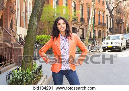 Mixed race woman standing on city street View Large Photo Image Stock Image - Mixed race woman standing on city street. Fotosearch