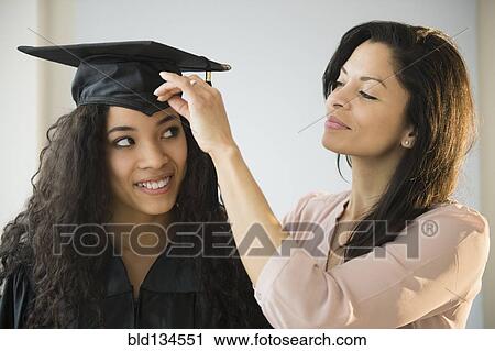 Mother adjusting teenage daughter's graduation cap View Large Photo Image Stock Image - Mother adjusting teenage daughter's graduation cap. Fotosearch