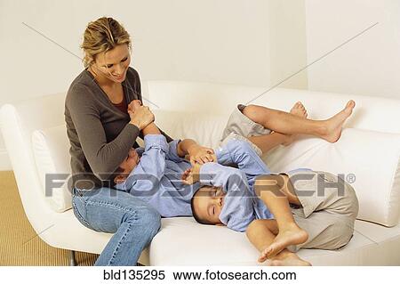 Mother and children playing on sofa View Large Photo Image Stock Photography - Mother and children playing on sofa. Fotosearch