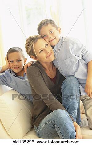Mother and children smiling on sofa View Large Photo Image Stock Photograph - Mother and children smiling on sofa. Fotosearch