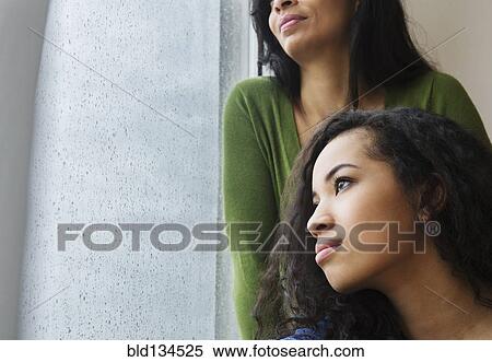Mother and daughter daydreaming at window View Large Photo Image Stock Photography - Mother and daughter daydreaming at window. Fotosearch