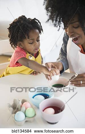 Mother and daughter dyeing Easter eggs View Large Photo Image Picture - Mother and daughter dyeing Easter eggs. Fotosearch