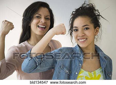 Mother and daughter flexing their muscles View Large Photo Image Stock Photo - Mother and daughter flexing their muscles. Fotosearch