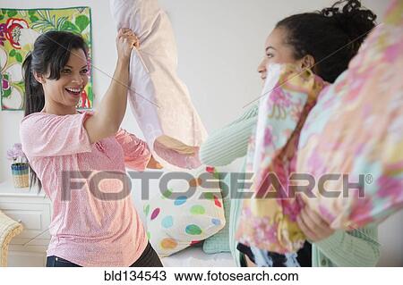 Mother and daughter having pillow fight View Large Photo Image Stock Image - Mother and daughter having pillow fight. Fotosearch