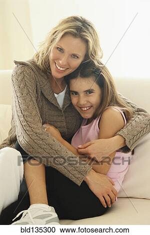 Mother and daughter hugging on bed View Large Photo Image Stock Image - Mother and daughter hugging on bed. Fotosearch