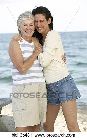 Mother and daughter hugging outdoors View Large Photo Image Stock Image - Mother and daughter hugging outdoors. Fotosearch