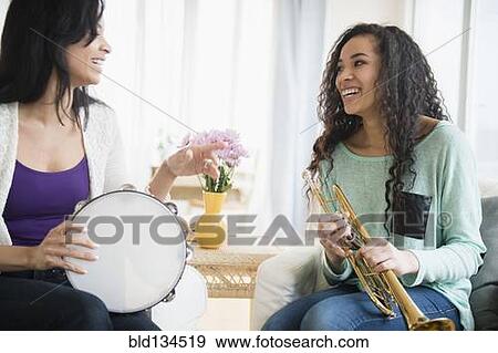 Mother and daughter playing music together View Large Photo Image Stock Photo - Mother and daughter playing music together. Fotosearch