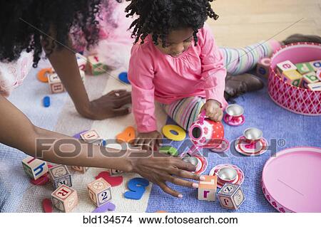 Picture - Mother and daughter playing together. Fotosearch