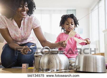 Mother and daughter playing with pots and pans View Large Photo Image Stock Photography - Mother and daughter playing with pots and pans. Fotosearch