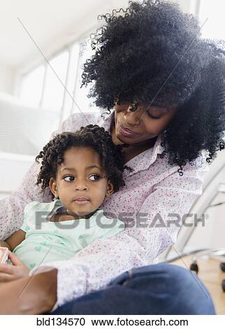 Stock Image - Mother and daughter relaxing together. Fotosearch