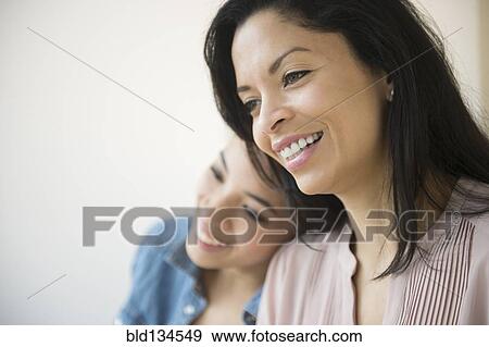 Stock Photo - Mother and daughter smiling together. Fotosearch