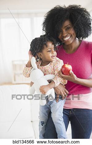 Stock Photograph - Mother and daughter with apple. Fotosearch