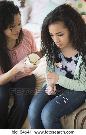 Mother comforting lovesick daughter with ice cream View Large Photo Image Stock Image - Mother comforting lovesick daughter with ice cream. Fotosearch