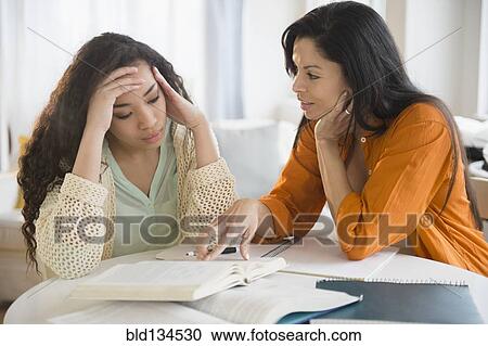 Mother helping daughter with homework View Large Photo Image Stock Image - Mother helping daughter with homework. Fotosearch