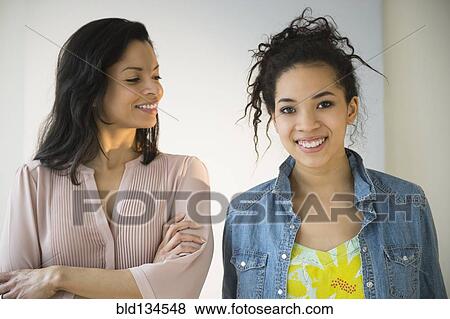 Mother smiling at teenage daughter View Large Photo Image Stock Photo - Mother smiling at teenage daughter. Fotosearch