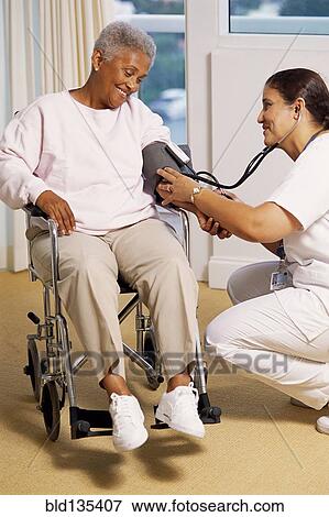 Nurse checking patient's blood pressure View Large Photo Image Stock Photo - Nurse checking patient's blood pressure. Fotosearch