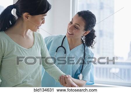 Nurse helping patient in hospital View Large Photo Image Stock Image - Nurse helping patient in hospital. Fotosearch
