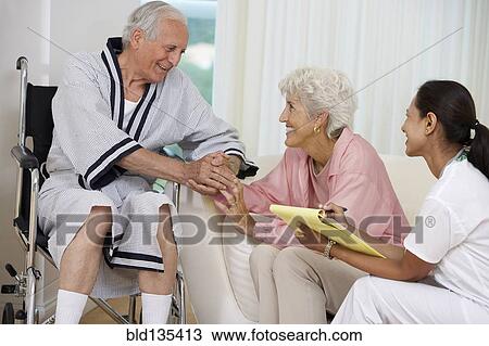 Nurse talking to Senior couple at home visit View Large Photo Image Stock Image - Nurse talking to Senior couple at home visit. Fotosearch