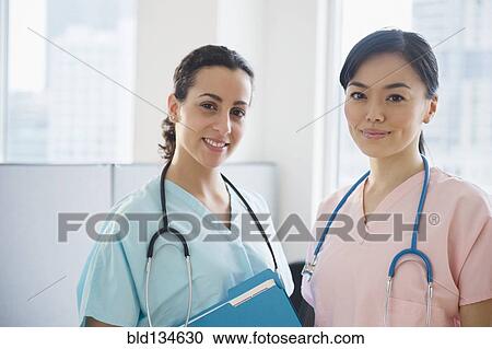 Nurses smiling together in hospital View Large Photo Image Stock Image - Nurses smiling together in hospital. Fotosearch